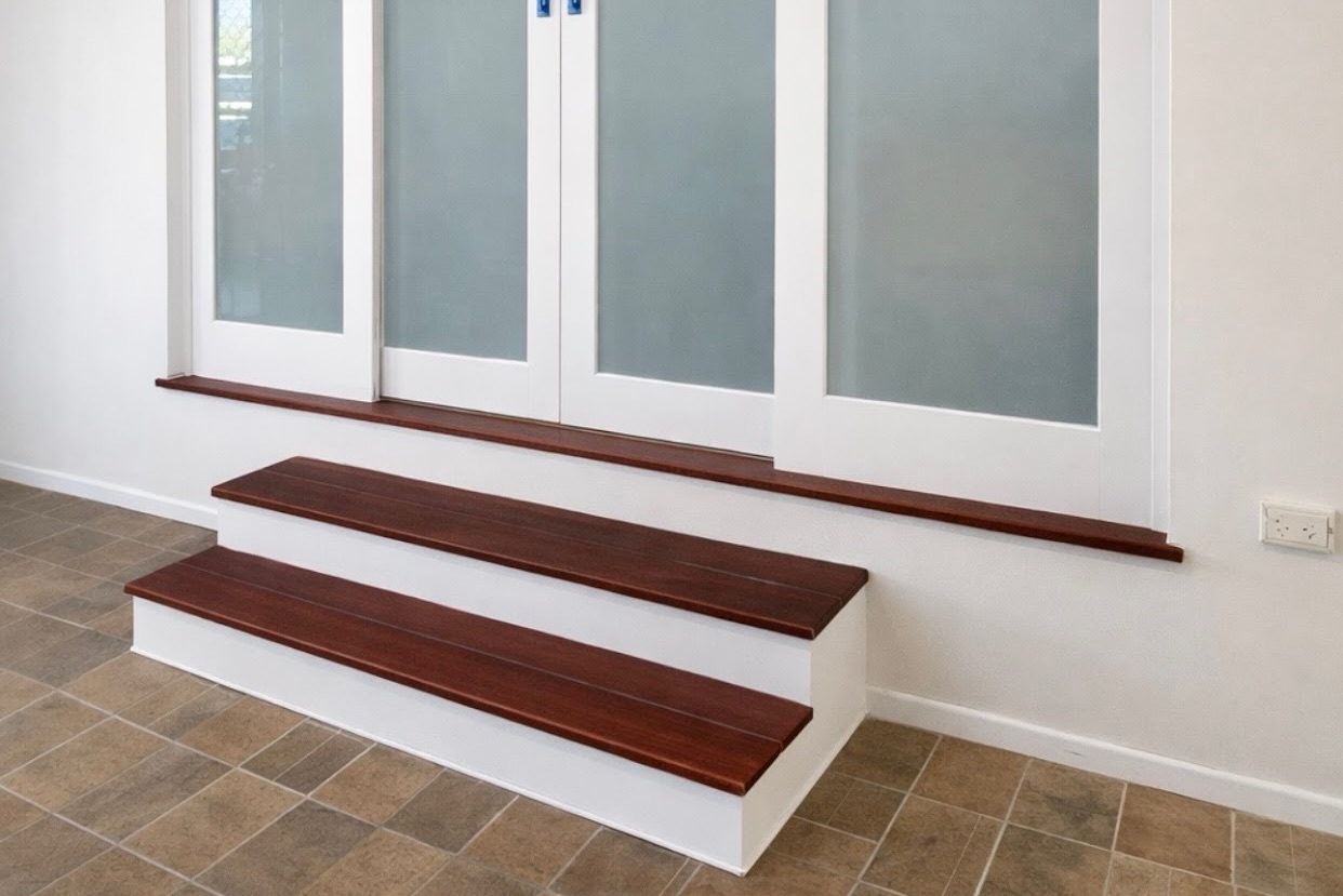 Custom Jarrah timber stairs and sliding glass doors installed in modern Toowoomba home entry