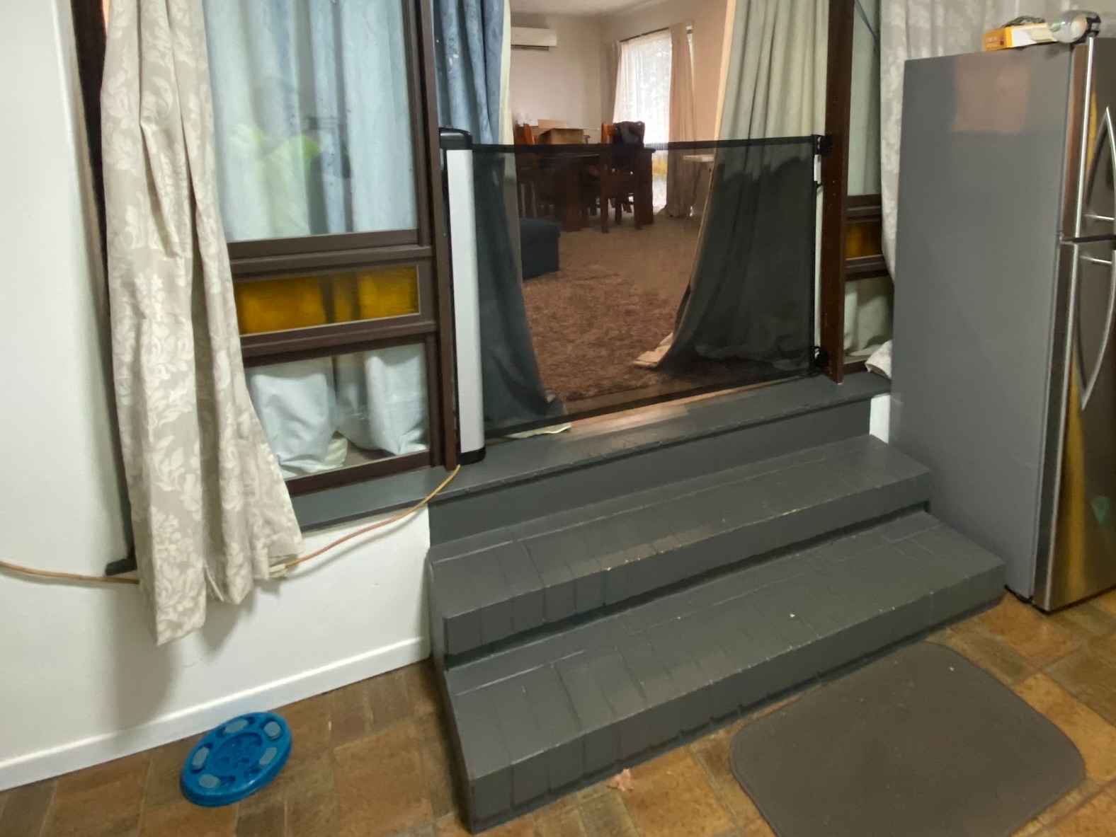 Outdated home entry with brick steps and aluminium doors before renovation in Toowoomba