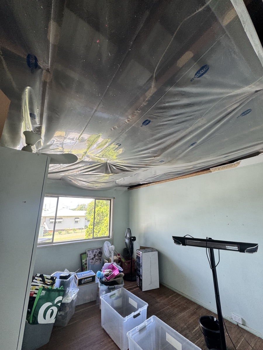 Storm damaged ceiling collapse with temporary plastic protection in Wilsonton